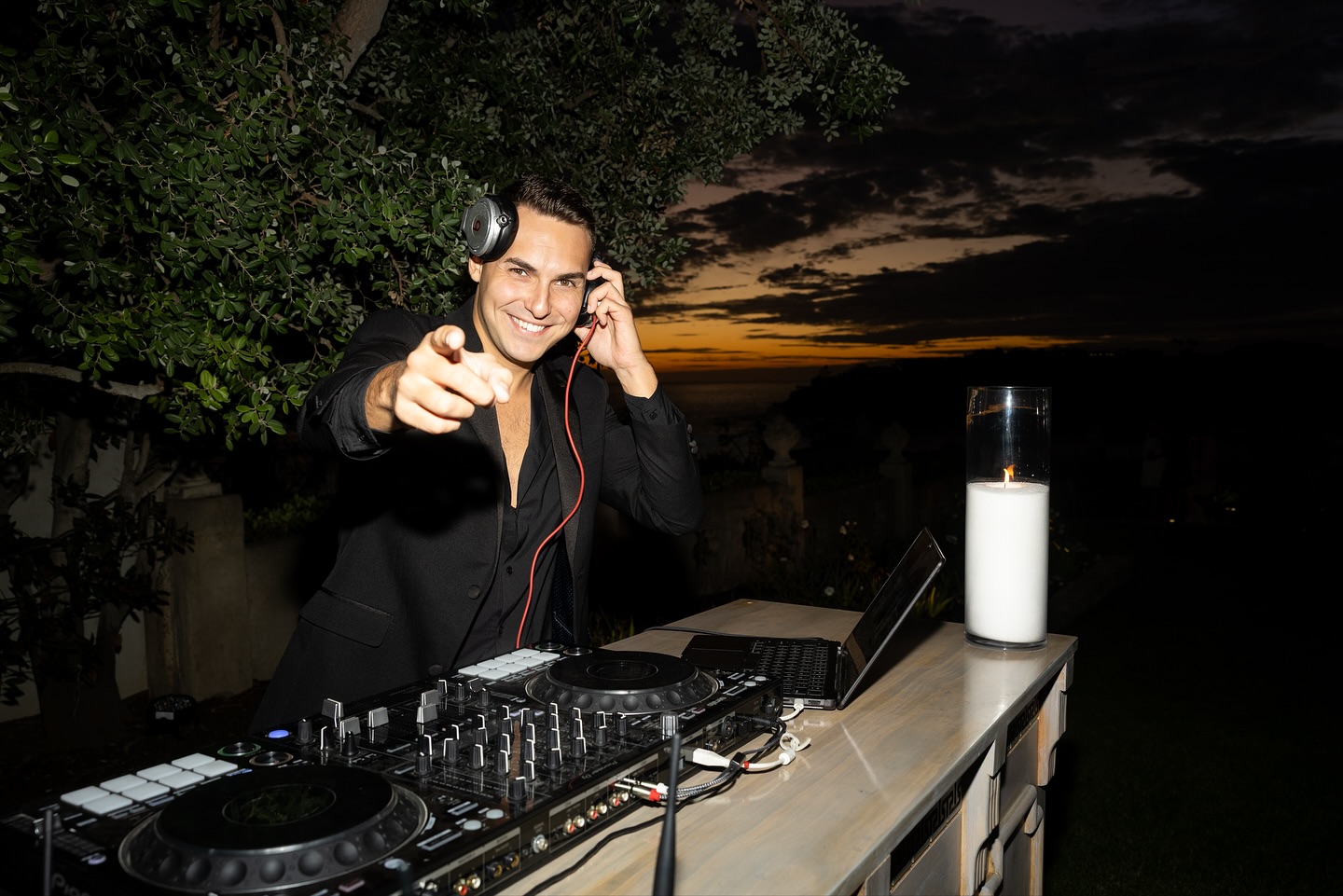 DJ ART behind the decks at an oceanfront event