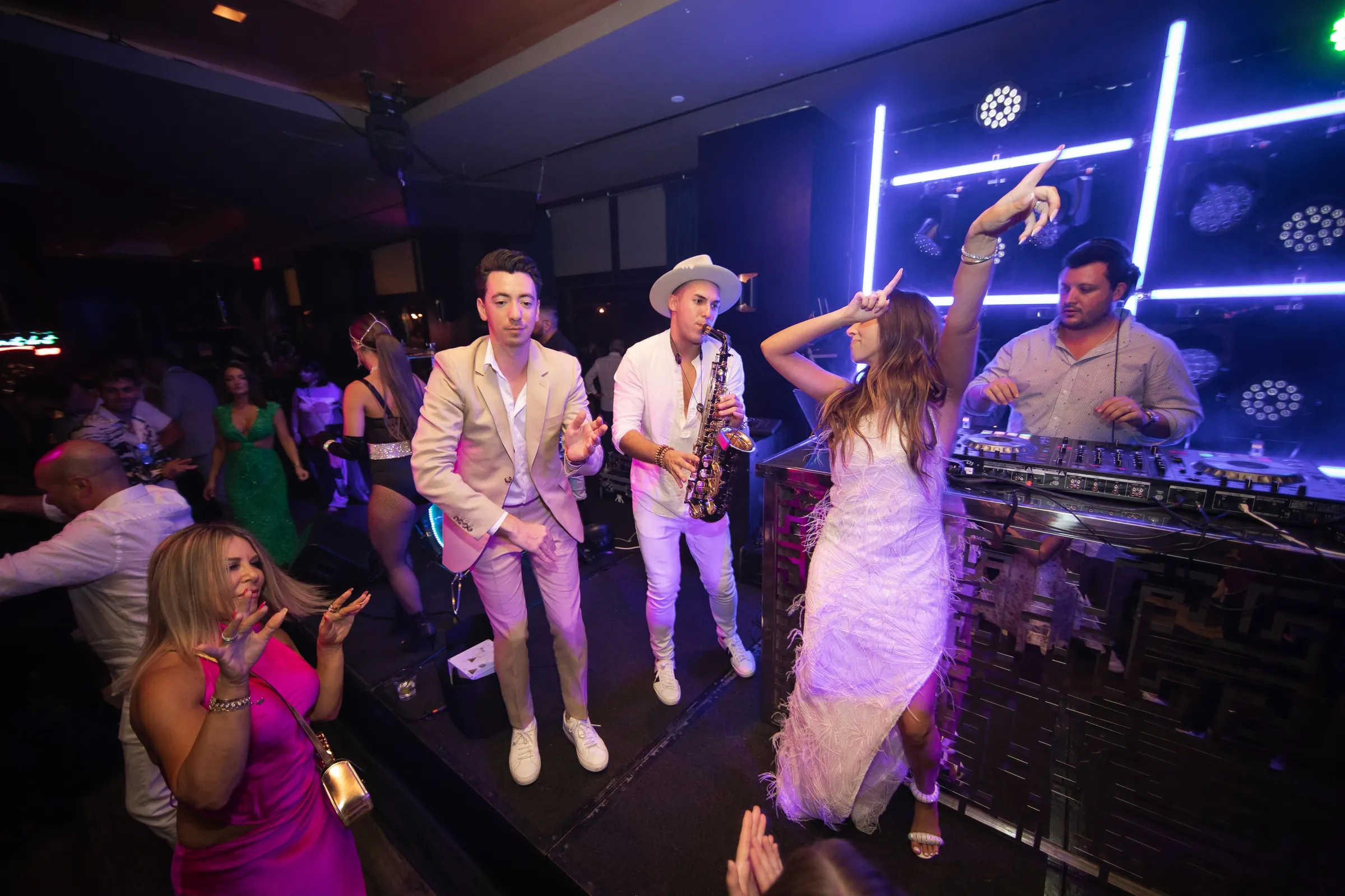 DJ ART performing with live saxophone on stage at a corporate party in Los Angeles